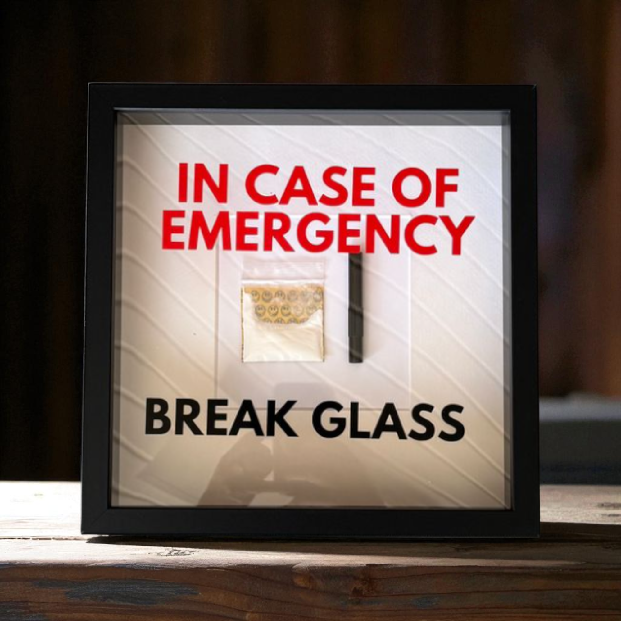 "In Case of Emergency Break Glass" – Wandbild mit Kokain Tütchen und Ziehröhrchen schwarzer Rahmen